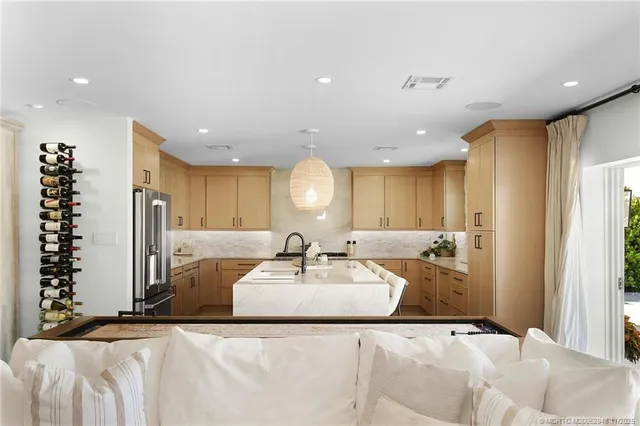 a large bedroom with a large bed and a chandelier