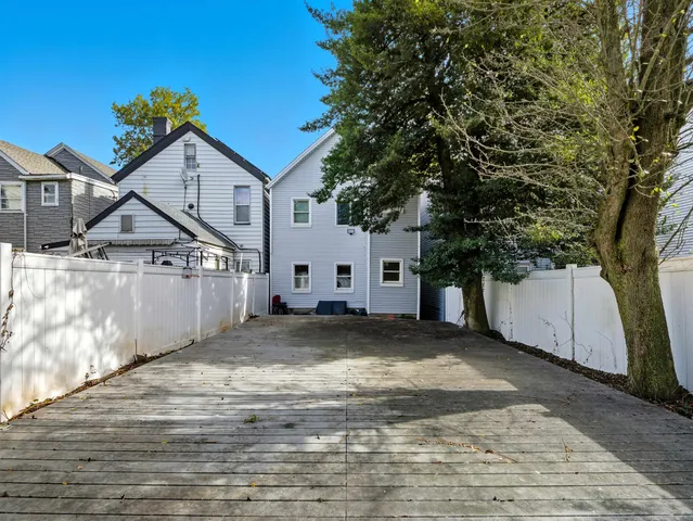 a view of a house with wooden floor and fence
