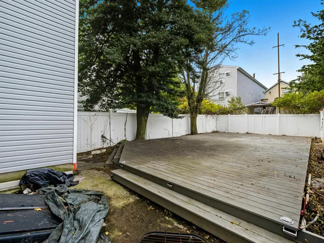 a backyard of a house with wooden deck