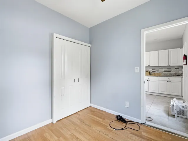 a view of a room with wooden floor and cabinets