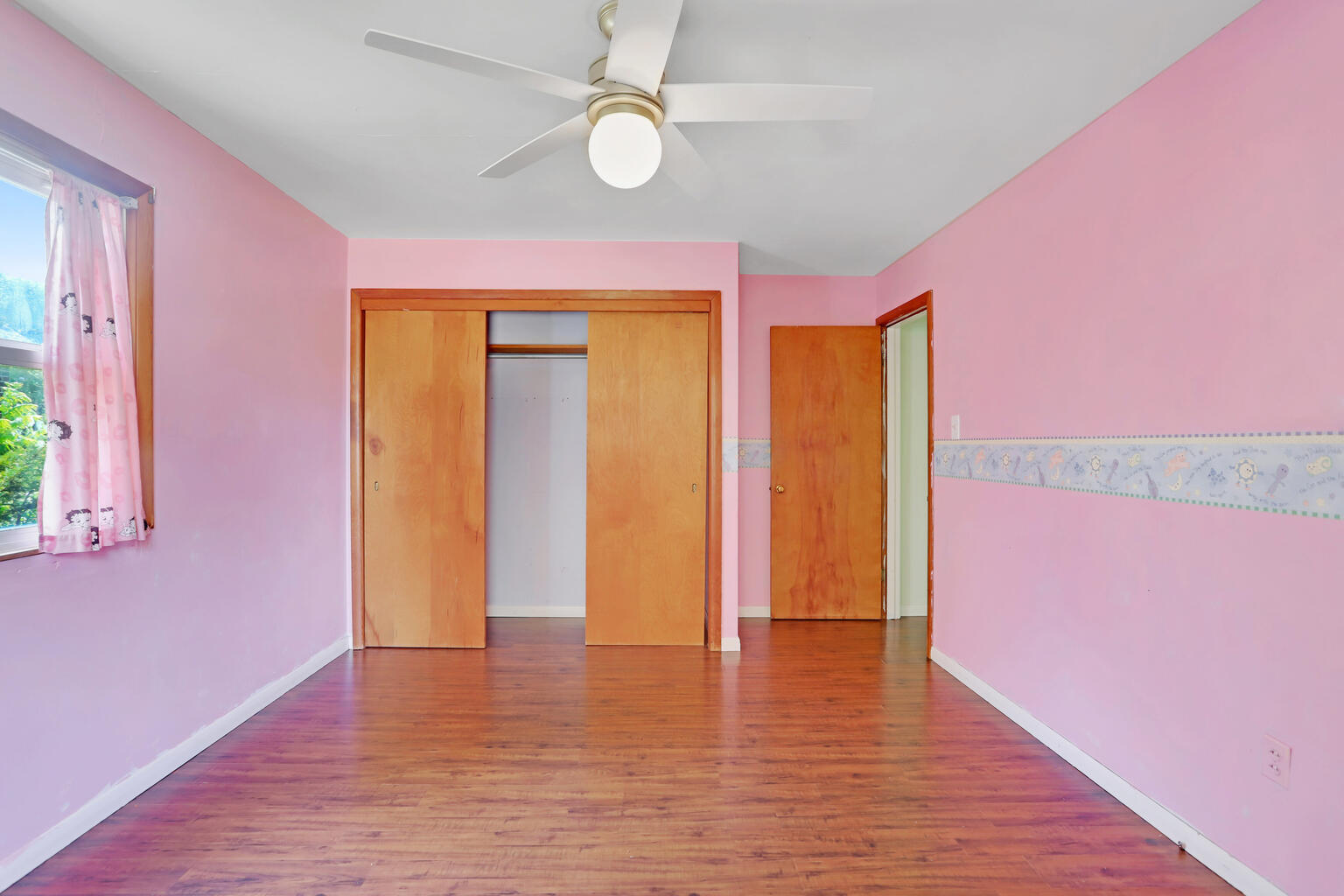 1220 West Semor Drive Decatur, IL 62521 - Photo 26 of 27 a view of an empty room with window and wooden floor