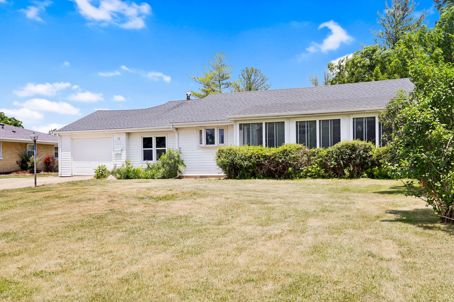 1220 West Semor Drive Decatur, IL 62521 - Photo 3 of 27 a front view of a house with a yard and potted plants