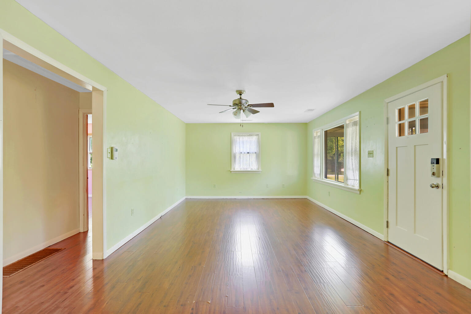 1220 West Semor Drive Decatur, IL 62521 - Photo 8 of 27 a view of an empty room with wooden floor and a window