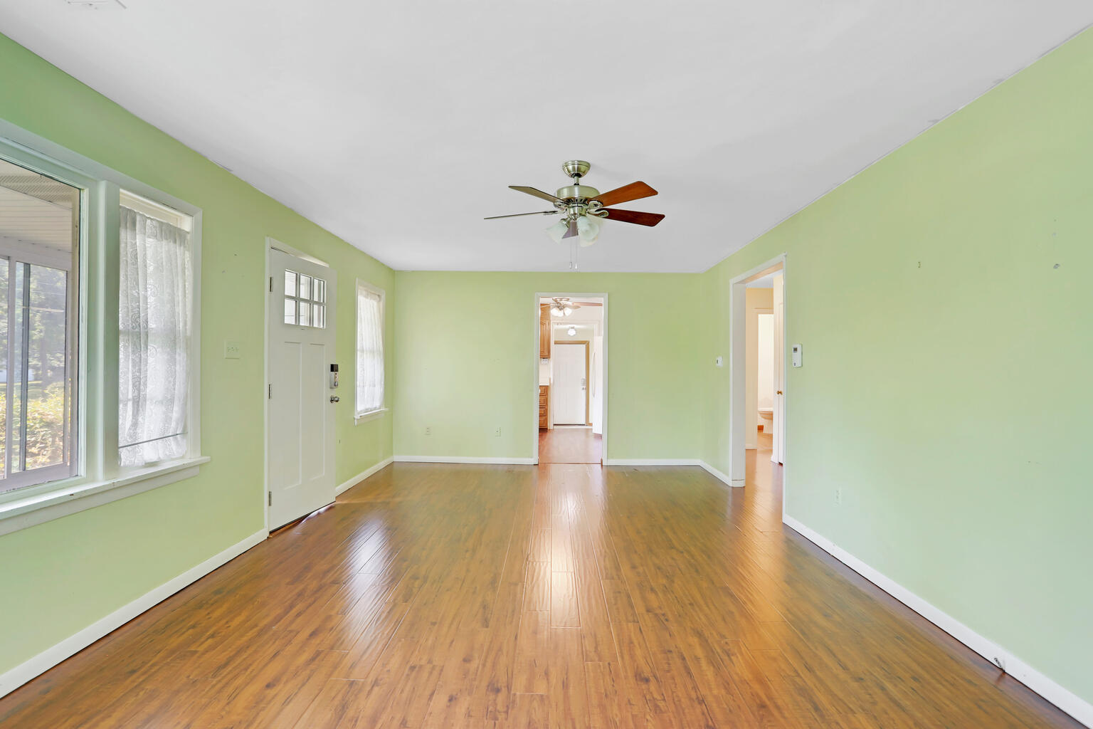1220 West Semor Drive Decatur, IL 62521 - Photo 9 of 27 a view of an empty room with window and wooden floor