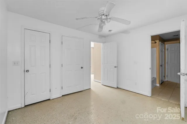 a view of a chandelier fan and entryway