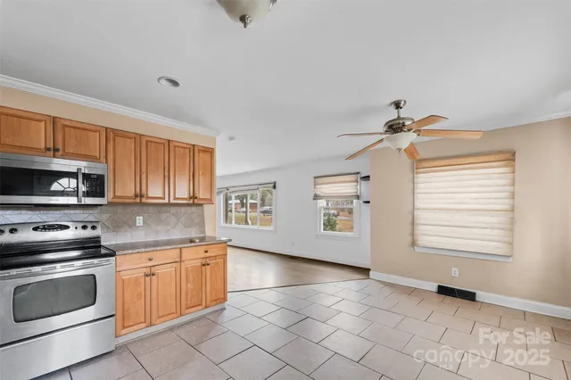 a kitchen with a stove a sink and a microwave