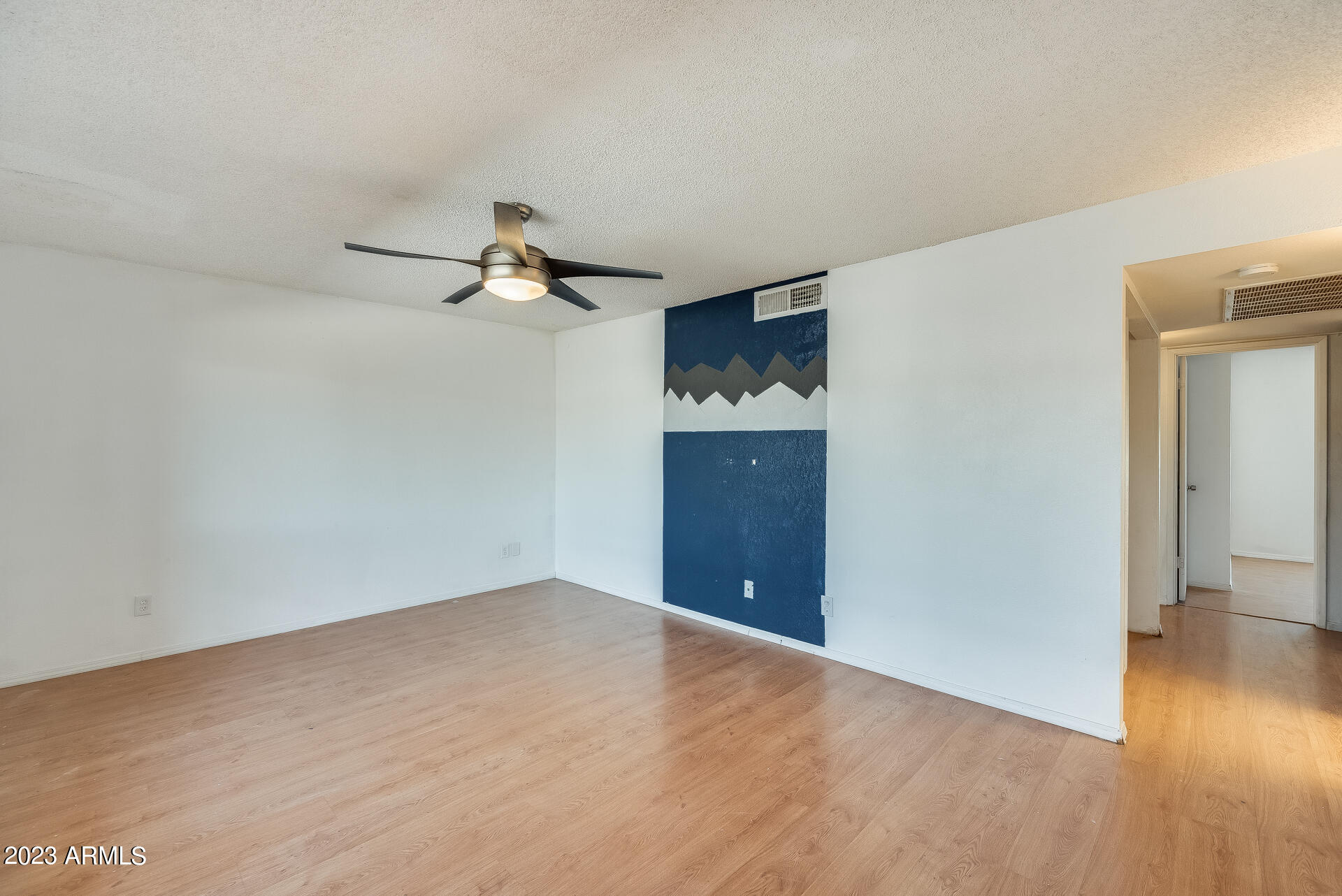 202 East Ruth Avenue, Unit 11 Phoenix, AZ 85020 - Photo 2 of 22 a view of an empty room and wooden floor