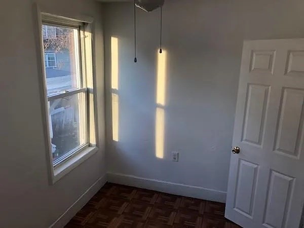 32 Wamesit Street, Unit 2 Lowell, MA 01852 - Photo 3 of 9 a view of empty room with windows and wardrobe