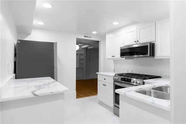 a view of a room with wooden floor and white walls