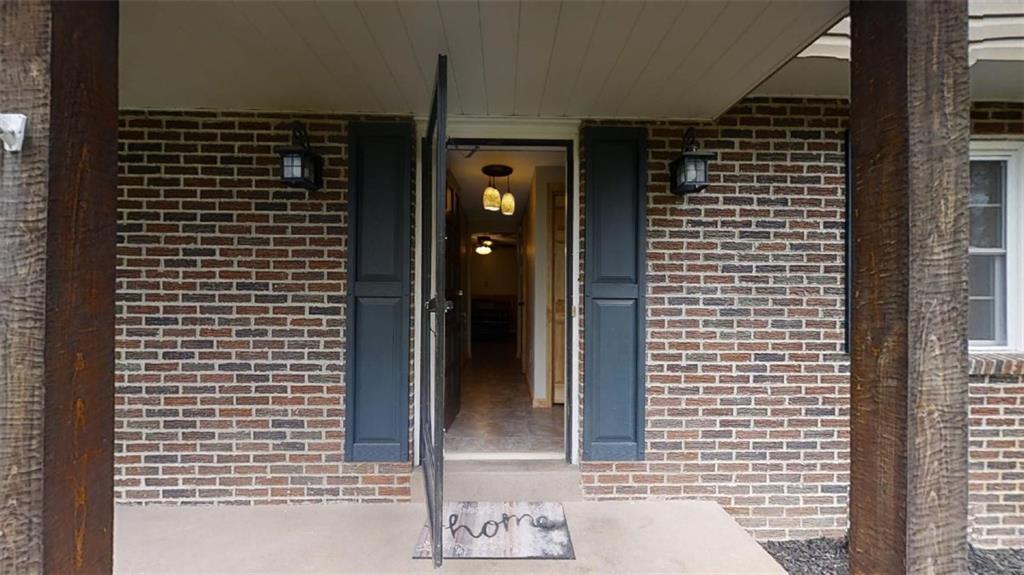 FRONT PORCH: 23 X 4: Newly Refinished Granite-Grip on Concrete Pad, New Aluminum Cladding on Ceiling, New Light Fixtures, New Shutters, New Vinyl Siding, New Wood Wrapped Posts, New Windows Throughout, Brick Facade