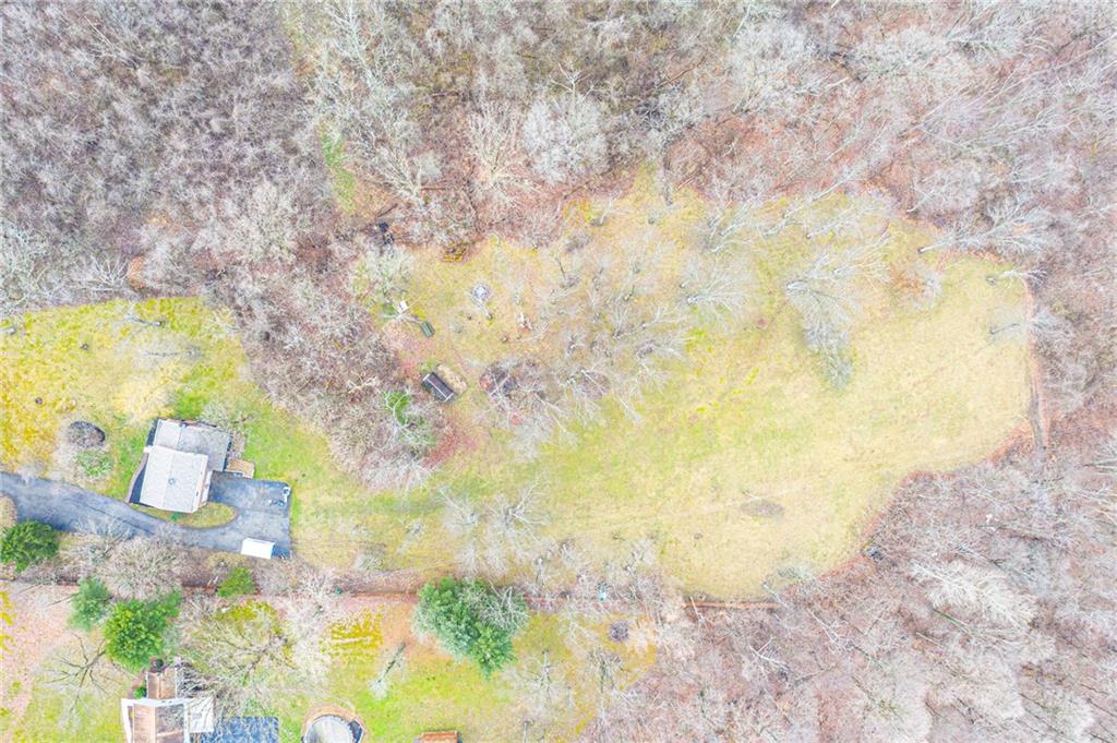 EXTERIOR: 3.5 Acres: New Vinyl Siding, Brick Faade, New Shutter, New Double-Pane New , Construction, Anderson Windows with Built-in Muttons, New Roof, New Gutters and Downspouts, New Soffit and Fascia, Two Freshly Painted Sheds, Newly refinished Privacy Fence, 15-20 Car Driveway, 2500 Gallon Cistern, Optional 200-foot Well, Septic System (Maintained by Hapchuk)