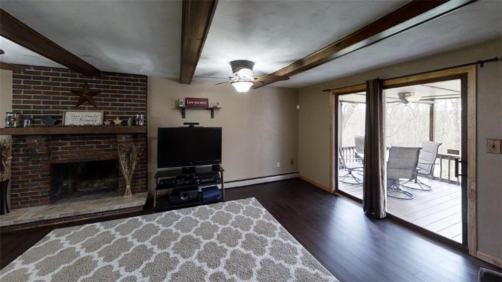 111 Valley View Road Eighty Four, PA 15330 - Photo 8 of 25 FAMILY ROOM: 234 X 135: New Bamboo Hardwood Flooring, New Ceiling Fans (2), New Solid Wood Trim, Brick Wood-Burning Fireplace, Rustic Wood Beams, Sliding Glass Doors to Screened Porch, Fresh Neutral Paint