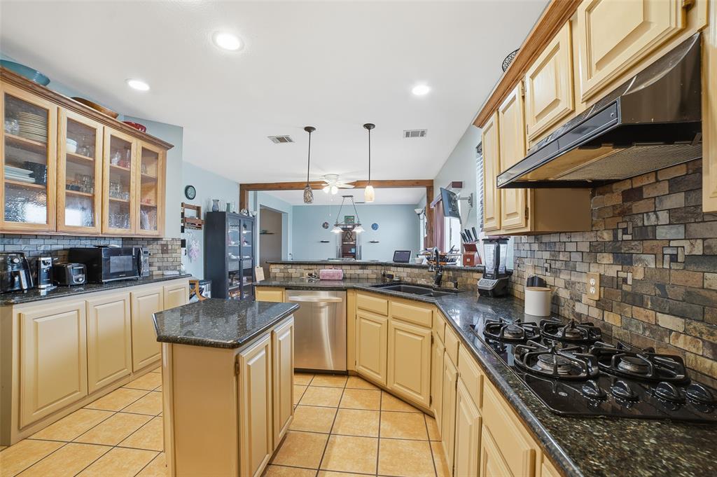 3613 Bermuda Drive Rowlett, TX 75088 - Photo 13 of 35 a kitchen with stainless steel appliances granite countertop a stove a sink and a microwave