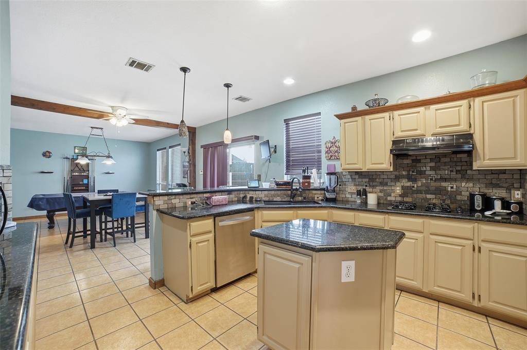 3613 Bermuda Drive Rowlett, TX 75088 - Photo 14 of 35 a kitchen with stainless steel appliances granite countertop a sink and a stove