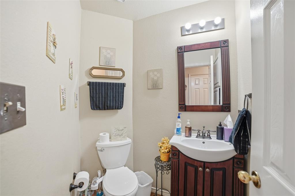 3613 Bermuda Drive Rowlett, TX 75088 - Photo 18 of 35 a bathroom with a toilet a sink and mirror