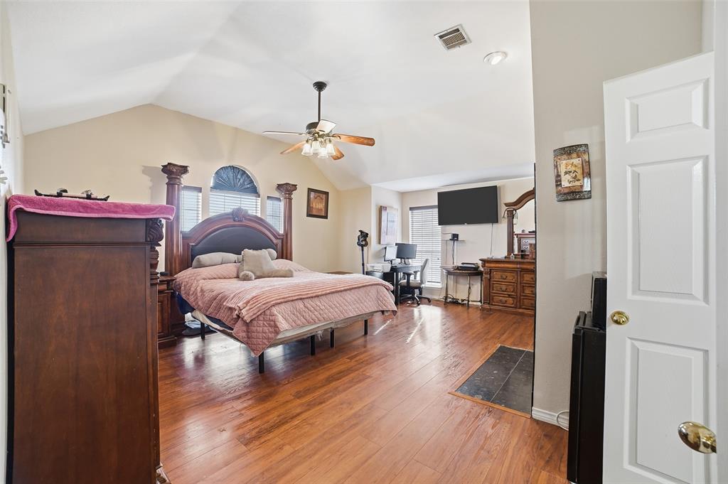 3613 Bermuda Drive Rowlett, TX 75088 - Photo 20 of 35 a spacious bedroom with a bed and a view of kitchen