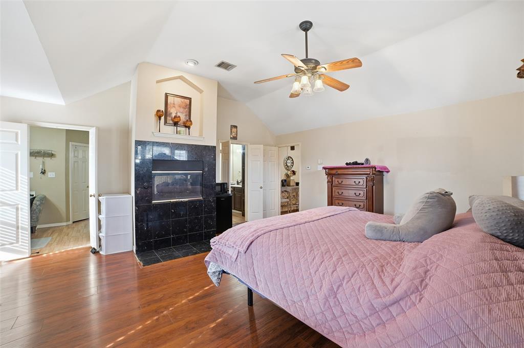 3613 Bermuda Drive Rowlett, TX 75088 - Photo 21 of 35 a bedroom with a bed and wooden floor