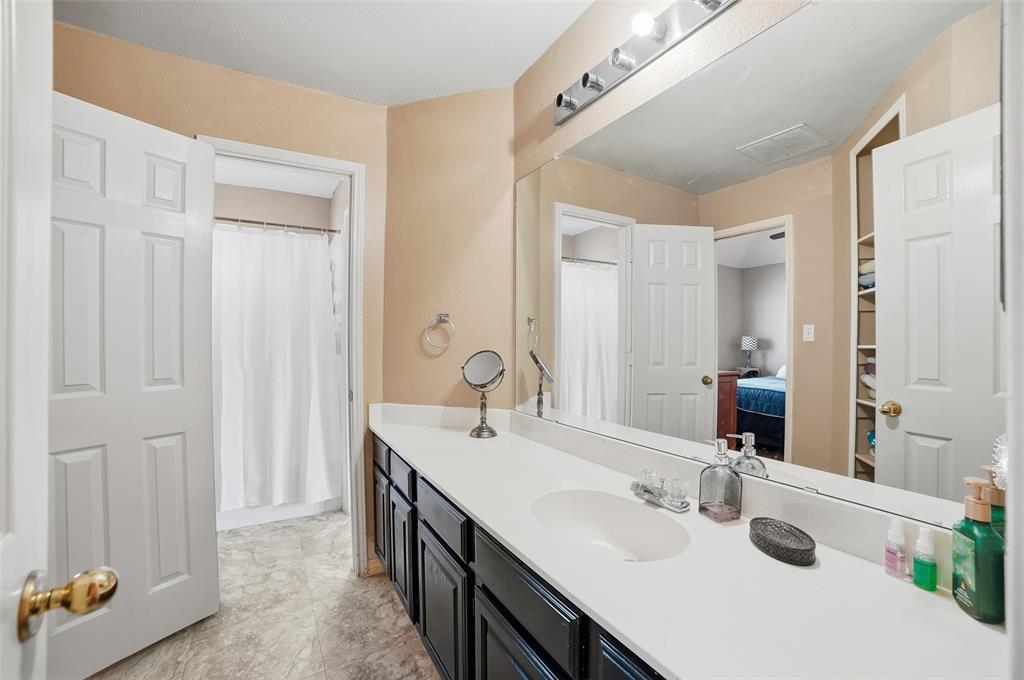 3613 Bermuda Drive Rowlett, TX 75088 - Photo 27 of 35 a bathroom with a sink and a mirror