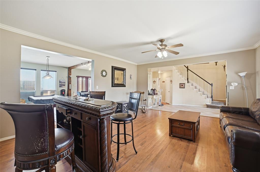 3613 Bermuda Drive Rowlett, TX 75088 - Photo 8 of 35 a living room with furniture a dining table and a stove with wooden floor