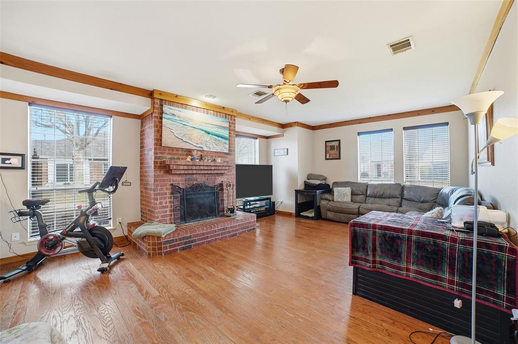3613 Bermuda Drive Rowlett, TX 75088 - Photo 9 of 35 a living room with furniture a fireplace and wooden floor