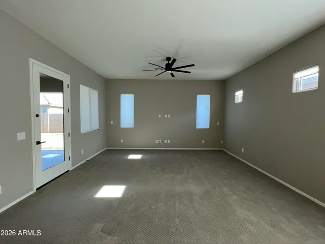 a view of an empty room with a ceiling fan