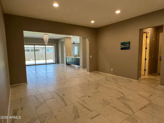 a view of an empty room with glass door
