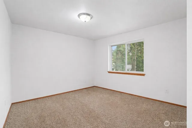 a bathroom with a granite countertop double vanity sink and a mirror