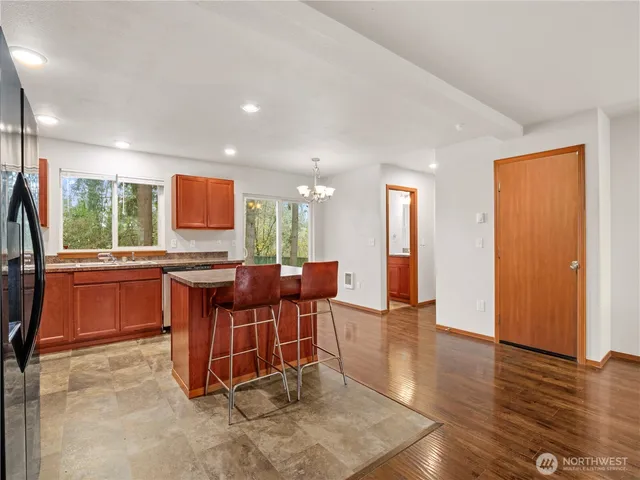 a open kitchen with dining table and chairs