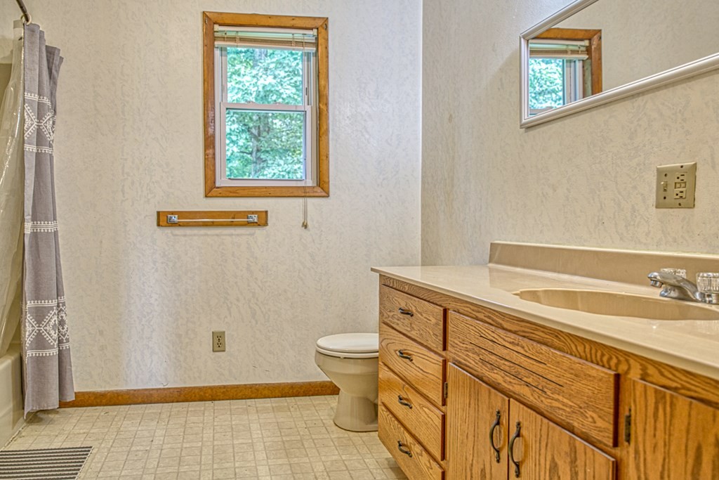 541 Bennett Road Sparta, TN 38583 - Photo 15 of 27 a bathroom with a sink a toilet a window and mirror