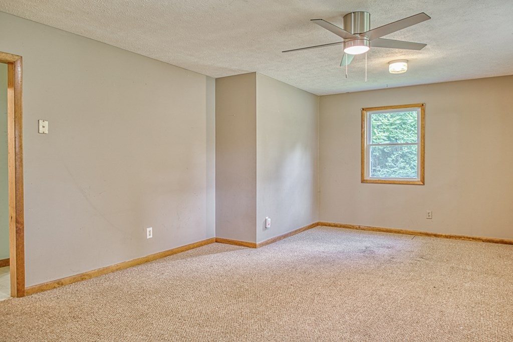 541 Bennett Road Sparta, TN 38583 - Photo 5 of 27 an empty room with fan and windows