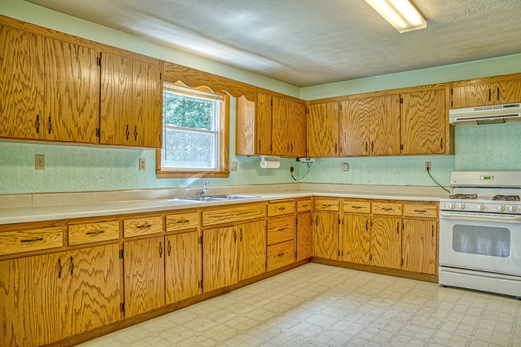 541 Bennett Road Sparta, TN 38583 - Photo 7 of 27 a kitchen with granite countertop cabinets sink and window