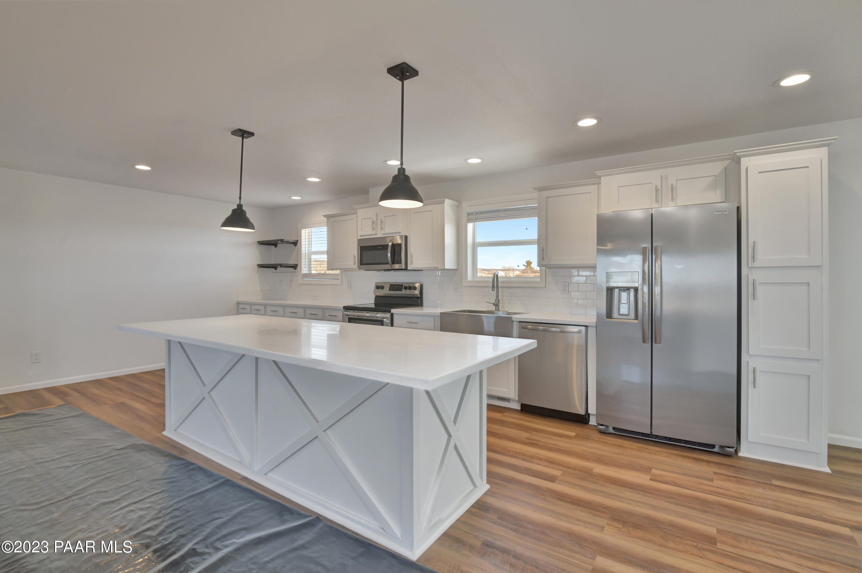 25325 North Mitchell Road Paulden, AZ 86334 - Photo 4 of 13 a kitchen with kitchen island a sink stainless steel appliances and wooden floor