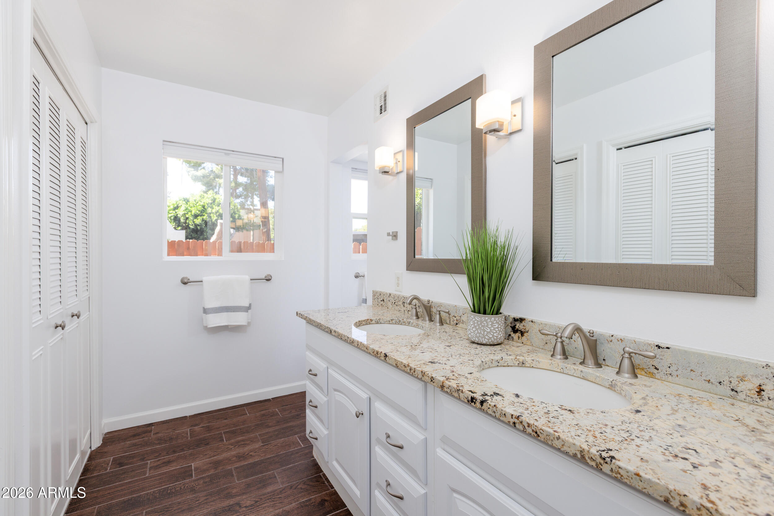 5550 North 12th Street, Unit 8 Phoenix, AZ 85014 - Photo 11 of 25 a bathroom with a granite countertop sink and a mirror