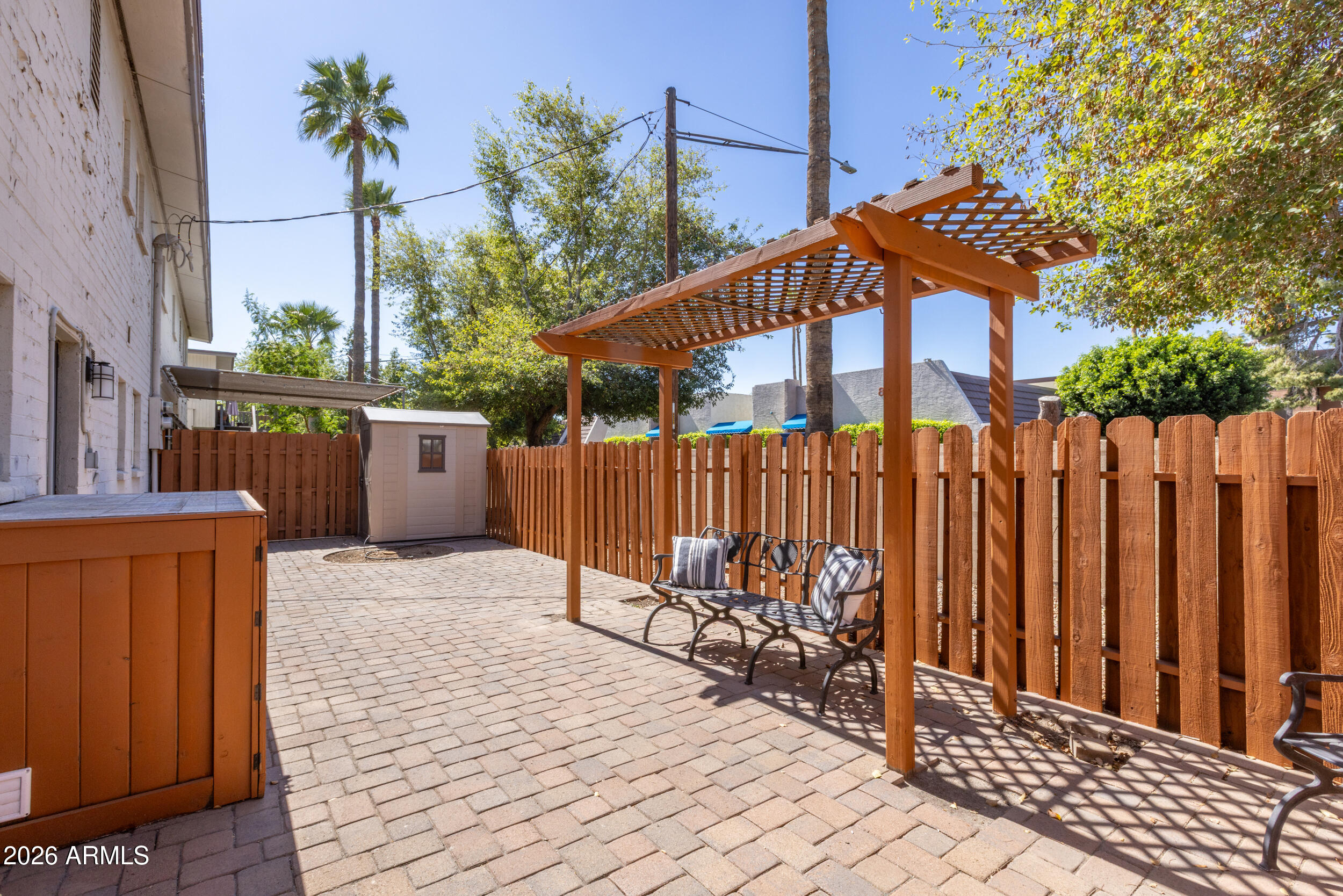 5550 North 12th Street, Unit 8 Phoenix, AZ 85014 - Photo 16 of 25 a backyard of a house with table and chairs