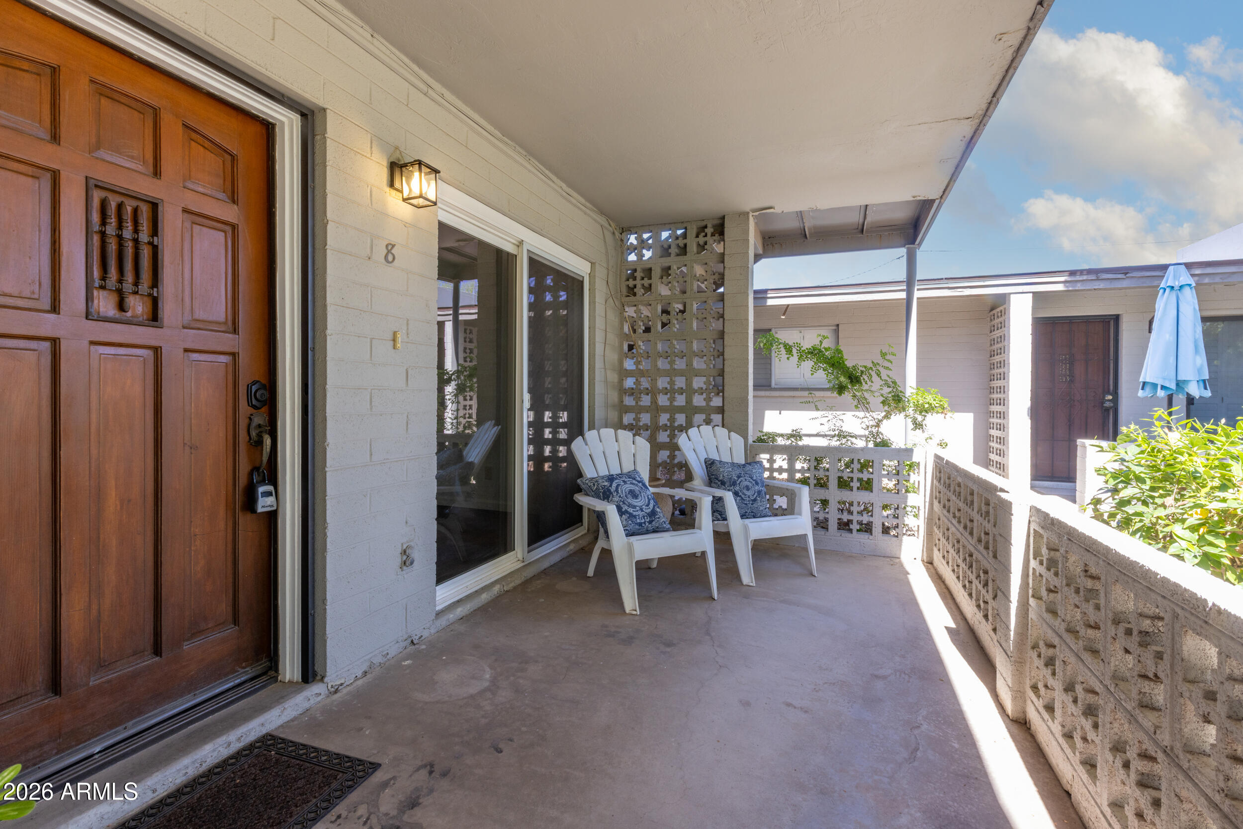 5550 North 12th Street, Unit 8 Phoenix, AZ 85014 - Photo 2 of 25 a view of a chairs and table in a balcony