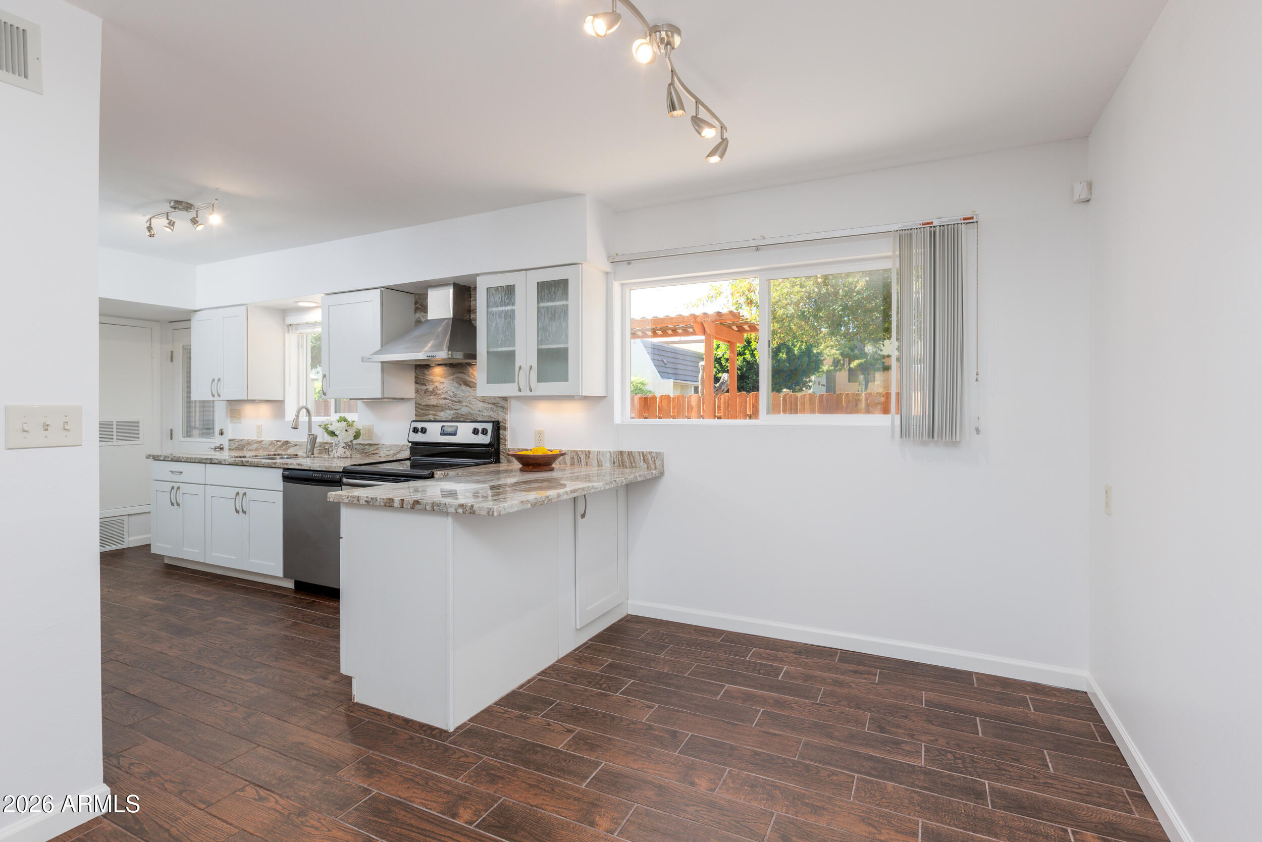 5550 North 12th Street, Unit 8 Phoenix, AZ 85014 - Photo 5 of 25 a kitchen with sink a window and cabinets
