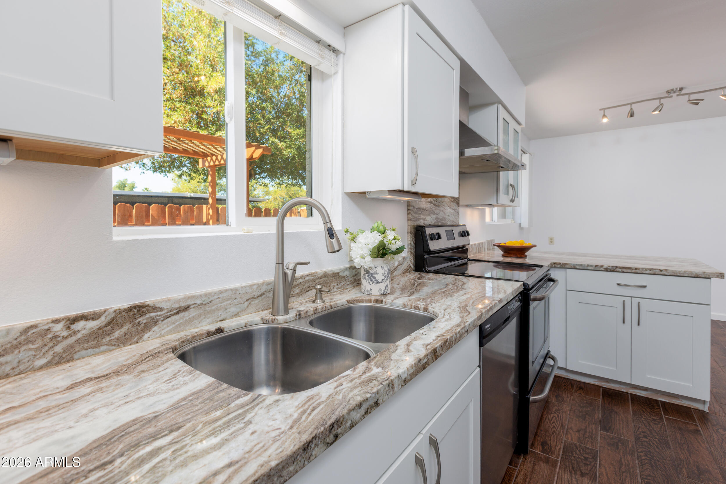 5550 North 12th Street, Unit 8 Phoenix, AZ 85014 - Photo 8 of 25 a kitchen with a sink cabinets and window