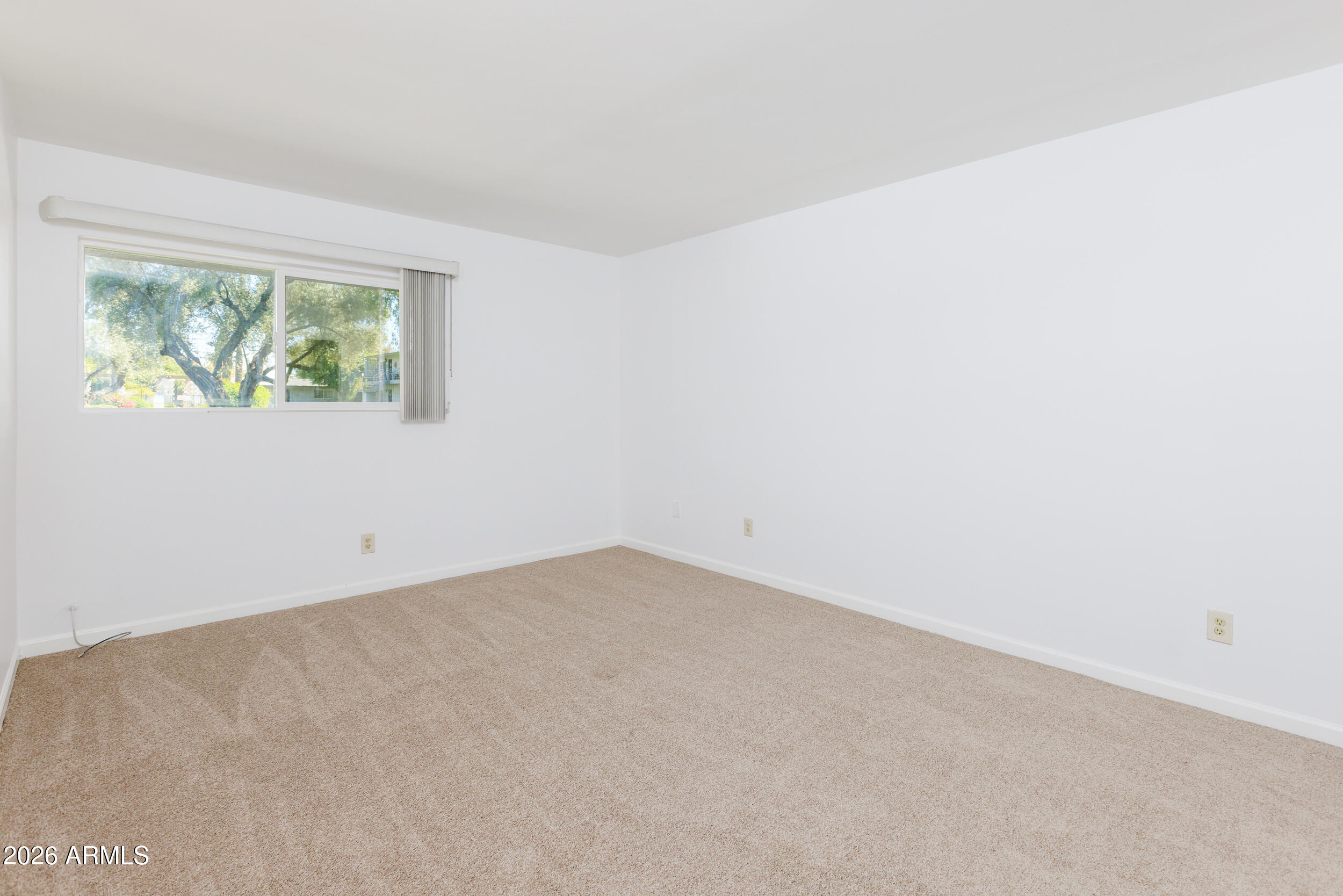 5550 North 12th Street, Unit 8 Phoenix, AZ 85014 - Photo 9 of 25 an empty room with windows