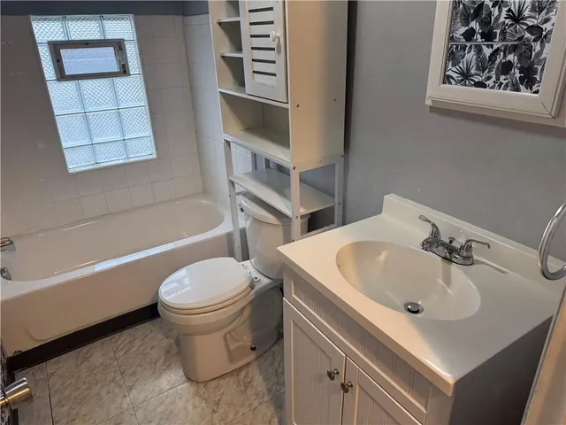 a bathroom with a sink toilet and bathtub