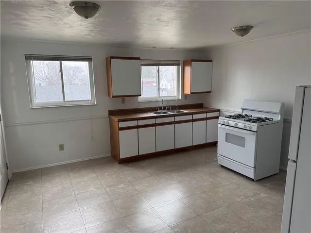 a kitchen with stainless steel appliances a stove sink and window