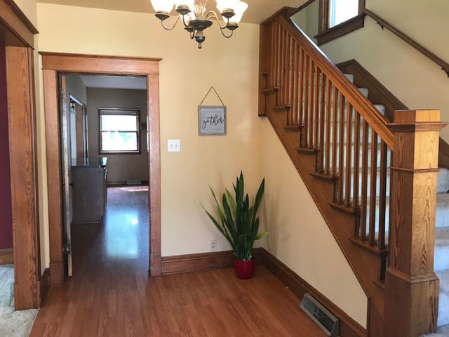 330 Woolf Court Rochelle, IL 61068 - Photo 2 of 15 a view of a hallway with wooden floor and stairs