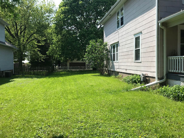 330 Woolf Court Rochelle, IL 61068 - Photo 15 of 15 a view of a house with a yard and a large tree