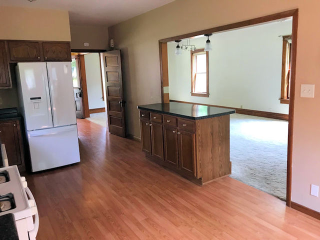 330 Woolf Court Rochelle, IL 61068 - Photo 4 of 15 wooden floor in an empty room with a window