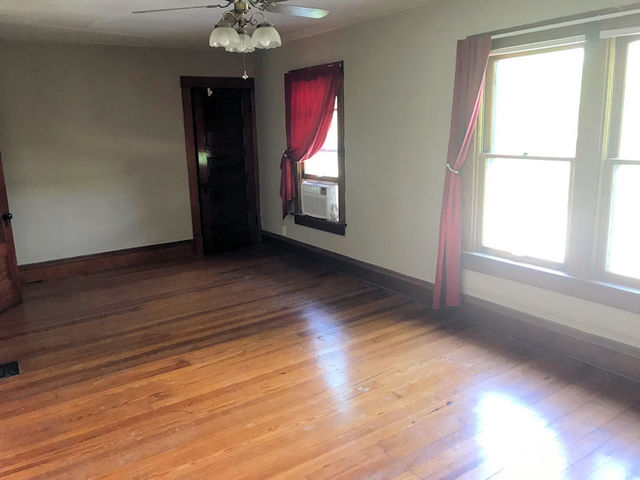 330 Woolf Court Rochelle, IL 61068 - Photo 7 of 15 a view of an empty room with wooden floor and a window