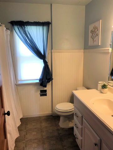 330 Woolf Court Rochelle, IL 61068 - Photo 10 of 15 a bathroom with a sink a toilet and a mirror