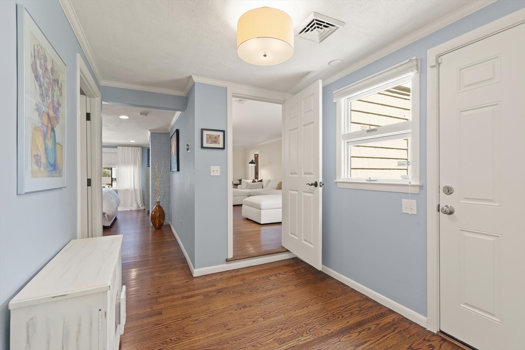 60 Amherst Road Newton, MA 02468 - Photo 11 of 25 a view of a hallway with wooden floor and a bathroom