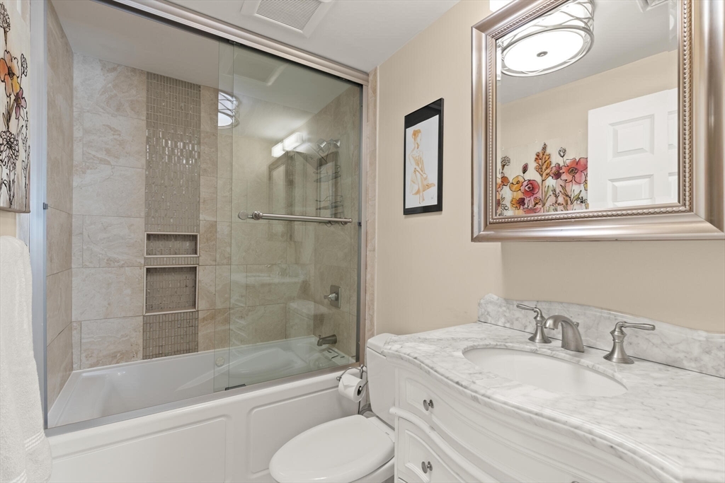 60 Amherst Road Newton, MA 02468 - Photo 14 of 25 a bathroom with a granite countertop sink toilet and shower