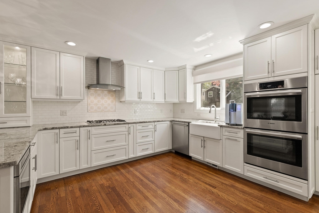 60 Amherst Road Newton, MA 02468 - Photo 4 of 25 a kitchen with granite countertop white cabinets stainless steel appliances and a sink