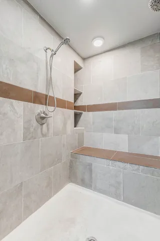 a bathroom with a shower and vanity