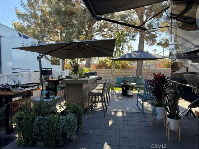 a view of a patio with table and chairs potted plants